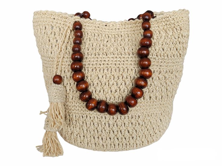 Experience the perfect blend of functionality and style with our Crochet Raffia Bucket Bag.  The natural color of the bag makes it versatile for any outfit, while the wooden bead handle adds a bohemian touch to the design.  The metal ballerina feet provide a sturdy base for the bag, ensuring your belongings are safe and secure.  With two internal pockets, this bucket bag is practical and functional, making it the perfect accessory for any occasion.  Made with high-quality materials, our Crochet Raffia Bucket Bag is not only durable but also stylish, making it the perfect investment for any fashion-conscious individual.  Get your hands on this unique and exclusive bucket bag today! ✪Size Width: 33 cm Height: 23 cm Bottom diameter: 20 cm Handle length(wood): 42 cm ✪Material Bag: paper yarn I Bohemian Light Brown Shoulder Bag For The Beach, Rectangular Natural Bag With Wooden Beads, Natural Rectangular Bag With Wooden Beads, Summer Beaded Natural Shoulder Bag, Bohemian Beaded Beige Bags, Natural Beaded Shoulder Bag For Summer, Bohemian Beaded Crochet Bag For The Beach, Brown Bag With Wooden Beads For Everyday Use, Bohemian Beaded Crochet Bag For Beach