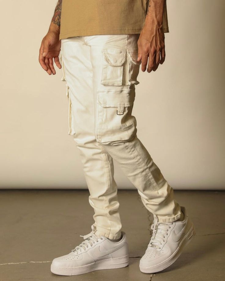 These jeans come in white. They are regular skinny jeans with cargo pockets on the sides of the legs. Made with high-quality denim, they are good pieces to add to your jean collection. Trendy White Cargo Pants For Fall, White Utility Cargo Pants For Fall, Cream Utility Bottoms With Cargo Style, White Casual Cargo Pants, Casual White Jeans With Cargo Pockets, Casual White Cargo Jeans, Casual White Cargo Jeans For Fall, White Utility Pants With Cargo Pockets, Trendy White Cargo Jeans With Multiple Pockets