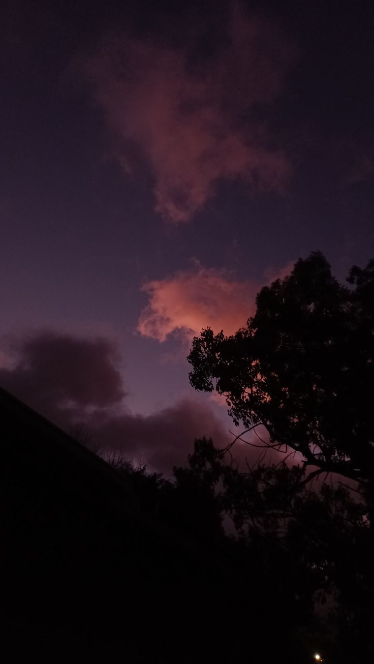 the sky is dark and purple with some clouds