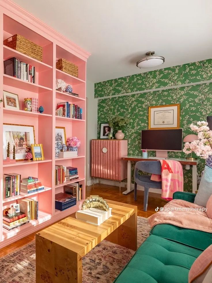 a living room filled with lots of furniture and bookshelves covered in pink paint