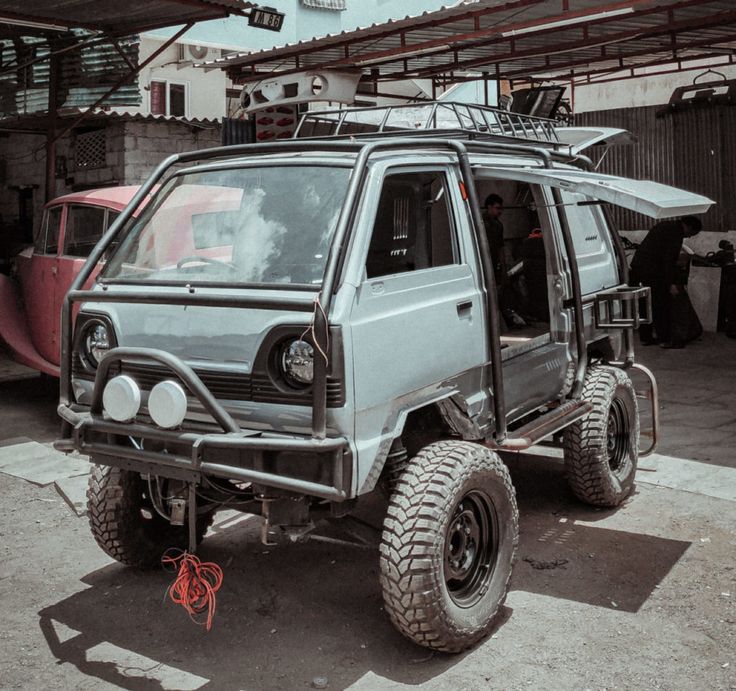 an off road vehicle parked in front of a building