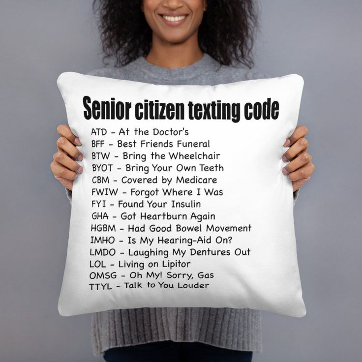 a woman holding up a pillow with the words senior citizen texting code on it