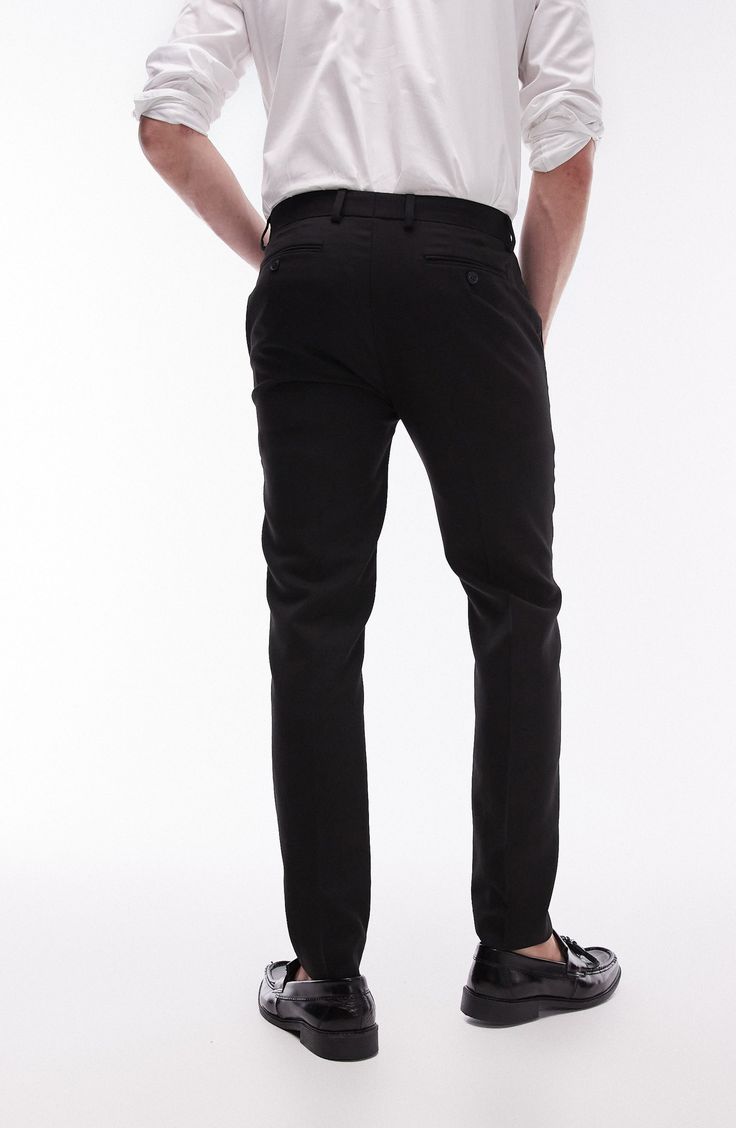 A lightly textured weave distinguishes neatly pressed trousers tailored in a skinny fit that looks smart whether worn with casual or formal styles. 30 1/2" inseam; 13" leg opening; 10 1/2" front rise; 14" back rise (size 32) Zip fly with hook-and-bar closure Front slant pockets; back welt pockets 64% polyester, 34% viscose, 2% elastane Dry clean Imported Stretch Elastane Pants For Semi-formal Occasions, Fitted Black Straight Leg Chinos, Semi-formal Stretch Elastane Bottoms, Full-length Chinos With Belt Loops For Business Casual, Business Casual Full-length Chinos With Belt Loops, Business Casual Full Length Chinos With Belt Loops, Fitted Black Chinos For Work, Semi-formal Stretch Straight Leg Pants, Tailored Black Straight Leg Chinos