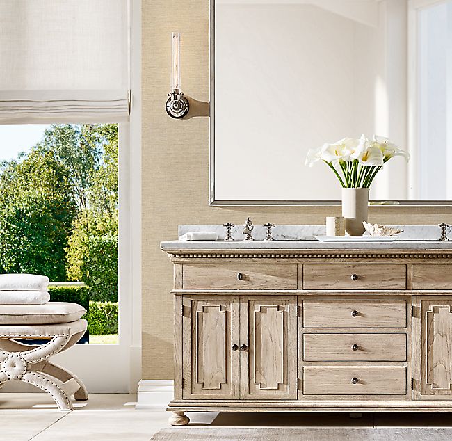 a bathroom with two sinks and a large mirror on the wall next to a window