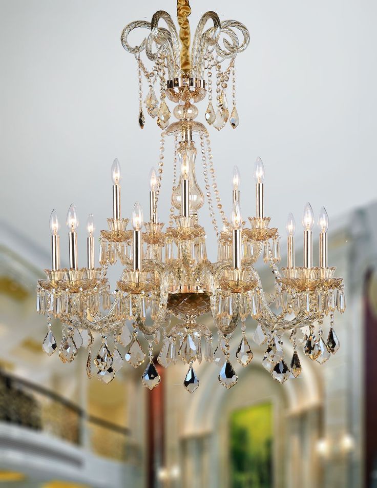 a gold chandelier with crystal drops hanging from it