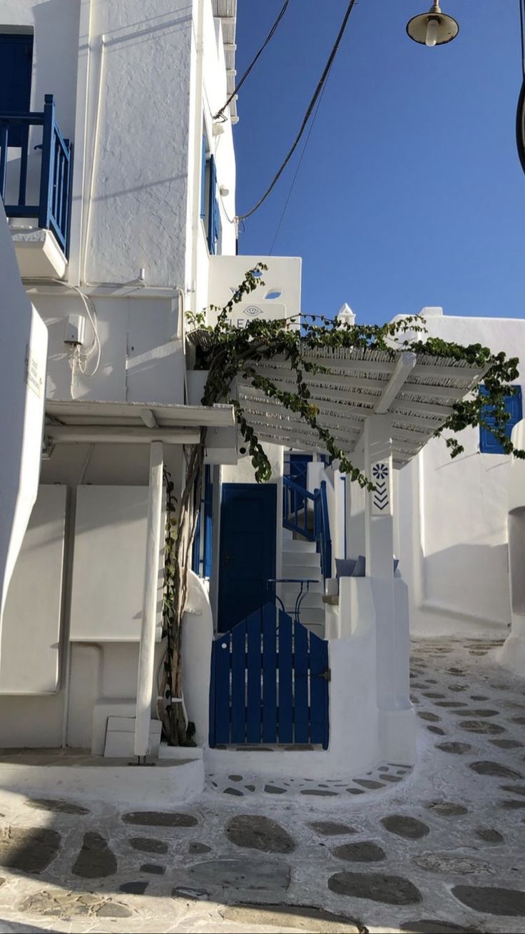 a white building with blue doors and windows