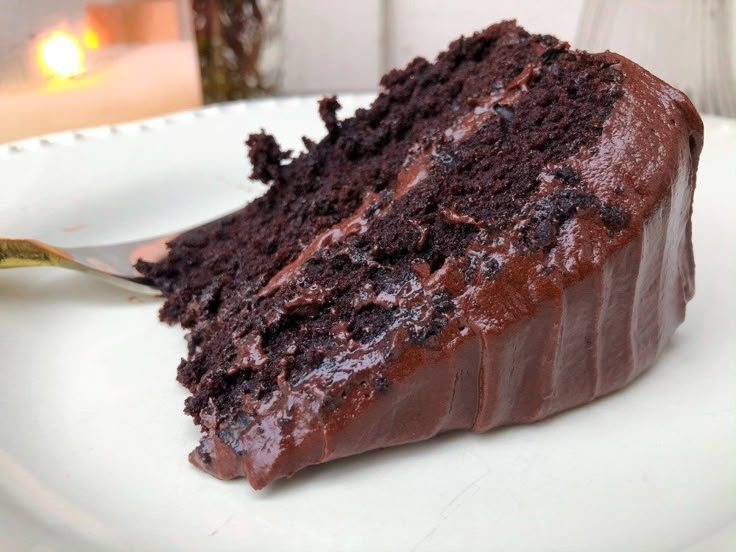 a slice of chocolate cake on a white plate