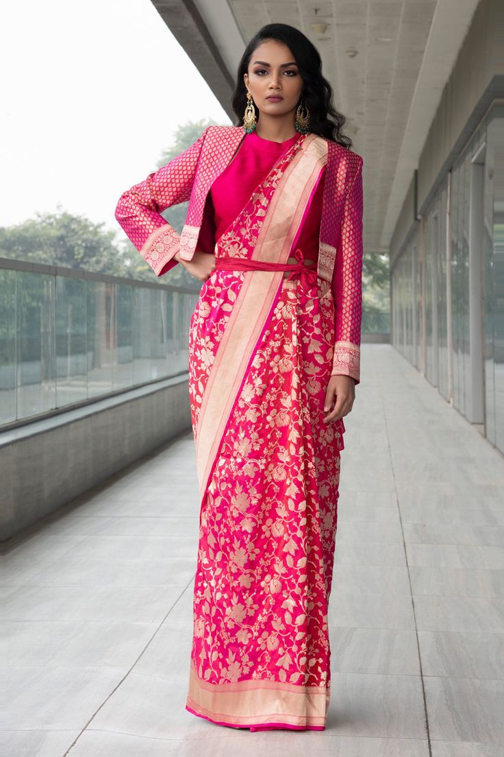 Fuchsia saree with Banarasi zari floral motifs. Paired with front-open floral brocade motif jacket and halter-neck blouse.
Component: 3

Neckline: Halter
Sleeve Length: Three quarter
Fabric: Saree: Pure Katan Silk, Blouse: Raw Silk, Jacket: Brocade
Color: Pink
Note: Bag and belt worn by the model is not for sale - Aza Fashions Jacket Blouse Designs For Saree, Jacket On Saree, Jacket Blouse Saree, Banarasi Saree Blouse Design Back, Brocade Saree Blouse Designs, Sari With Jacket, Banarasi Blouse Designs Latest, Brocade Blouse Designs Latest, Collar Blouse Designs For Saree