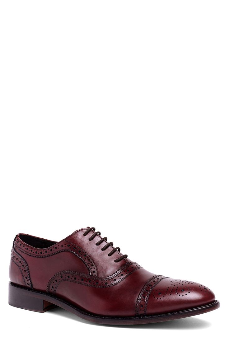 Brogue accents add charm to a stylish oxford topped with fine-grain leather while Goodyear welts ensure lasting durability. Leather upper and lining/rubber sole Imported Asian Owned/Founded Leather Oxford Shoes With Rubber Sole For Semi-formal Occasions, Semi-formal Oxford Shoes With Rubber Sole, Red Oxford Oxfords With Leather Sole, Red Oxfords With Leather Sole, Classic Oxford Leather Shoes With Textured Sole, Business Oxford Shoes With Brogue Detailing And Almond Toe, Red Lace-up Dress Shoes For Semi-formal Occasions, Classic Burgundy Leather Shoes With Rubber Sole, Classic Leather Shoes With Perforated Toe Box