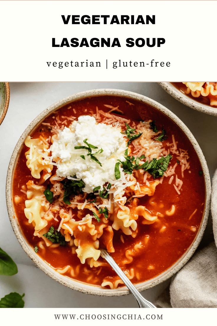 a bowl of vegetarian lasagna soup with cheese and spinach on the side