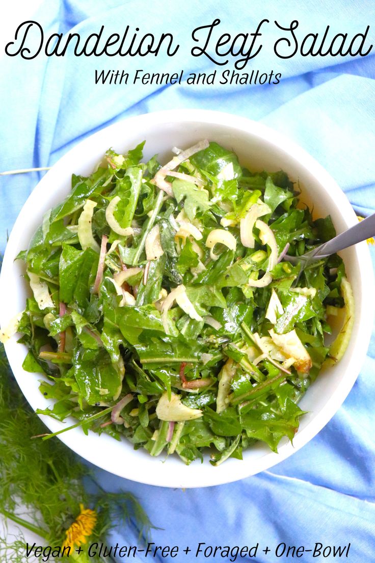 a white bowl filled with salad on top of a blue cloth