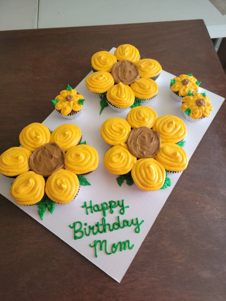 cupcakes with yellow frosting and sunflower decorations on a white card that says happy birthday mom