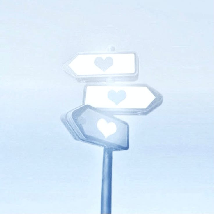 a street sign with two hearts on it's top and one heart at the bottom