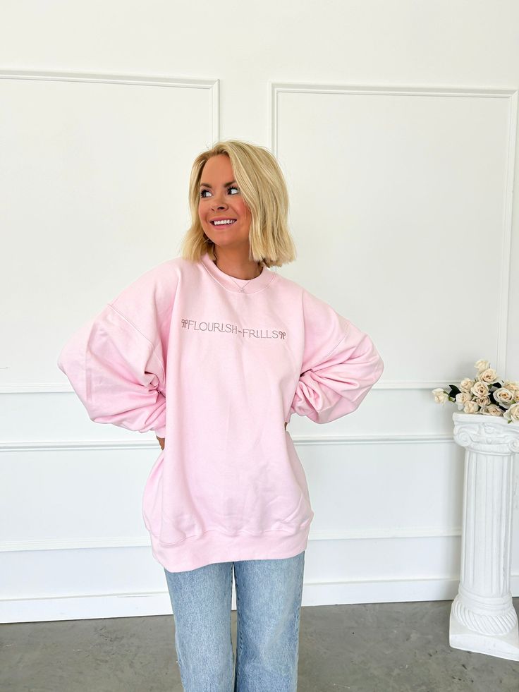 Stay cozy and stylish in the Flourish Coquette Sweatshirt. With its signature embroidered logo and frilly details, you'll stand out in this pink fleece-lined sweatshirt. Flourish in comfort and fashion all day long. Fleece lined Embroidered logo with bows 100% Cotton SIZE AND FIT:Fits TTS. Geordian is in a large for an extra oversized fit. Please reference size chart for detailed model measurements. *All photos have been enhanced to show color* Pink Relaxed Fit Crew Neck Sweater, Pink Crew Neck Fall Sweater, Pink Crew Neck Sweater For Fall, Oversized Pink Fleece Sweater, Pink Cozy Crew Neck Hoodie, Pink Sweatshirt For Fall Loungewear, Pink Relaxed Fit Sweatshirt For Fall, Cozy Pink Crew Neck Hoodie, Casual Pink Fleece Sweater