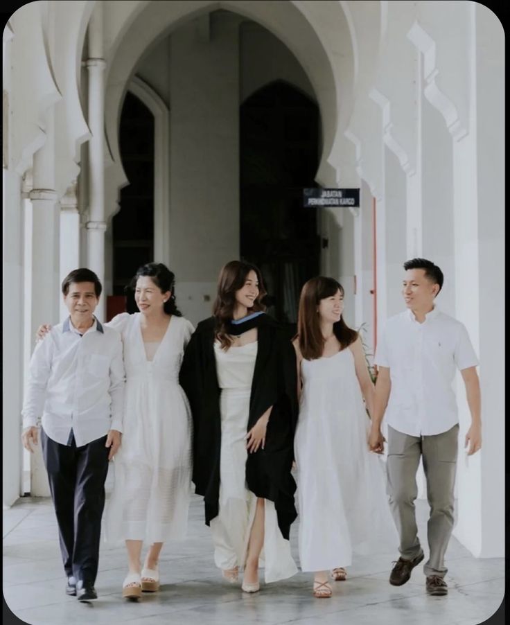 a group of people walking down a street next to each other