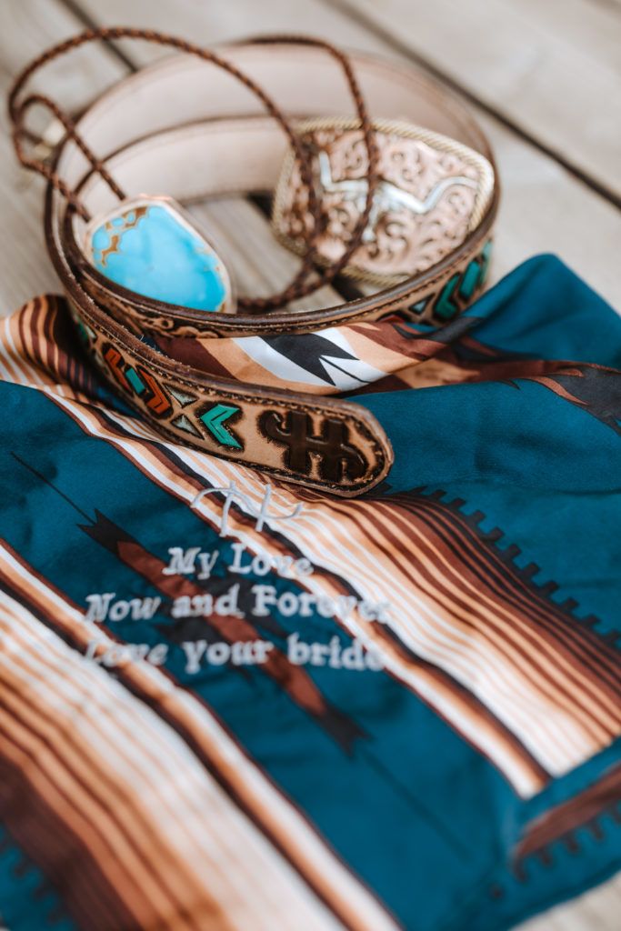 two bracelets on top of a blue and brown cloth with words written on it