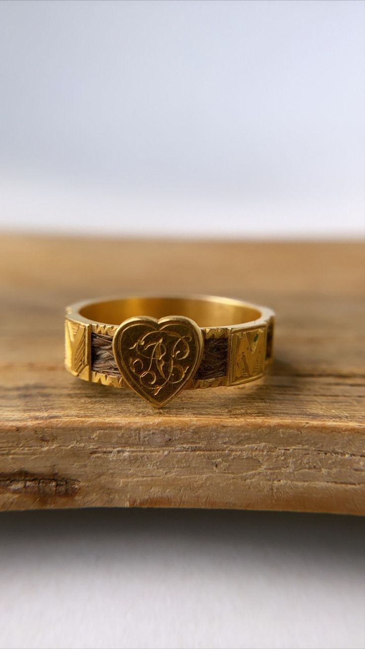 This is a beautiful antique mourning ring set in 18ct gold and dated from the Edwardian period. With woven hair covering the shank, interspersed with the letters MEMORY and a gold heart right in the centre with the initials A.P engraved on it. It's in very good condition with minor wear commensurate with age - there is some small engraving loss in the square of letter Y (as seen in photo). Crafted in solid 18ct gold, it has acquired a wonderful patina to it. Size: P/US7.5 (not resizable) Fully h Halo Ring Setting, Hair Covering, Cluster Ring Set, Spinel Ring, Letter Y, Hair Cover, Diamond Ring Settings, Diamond Cluster Ring, Moonstone Ring