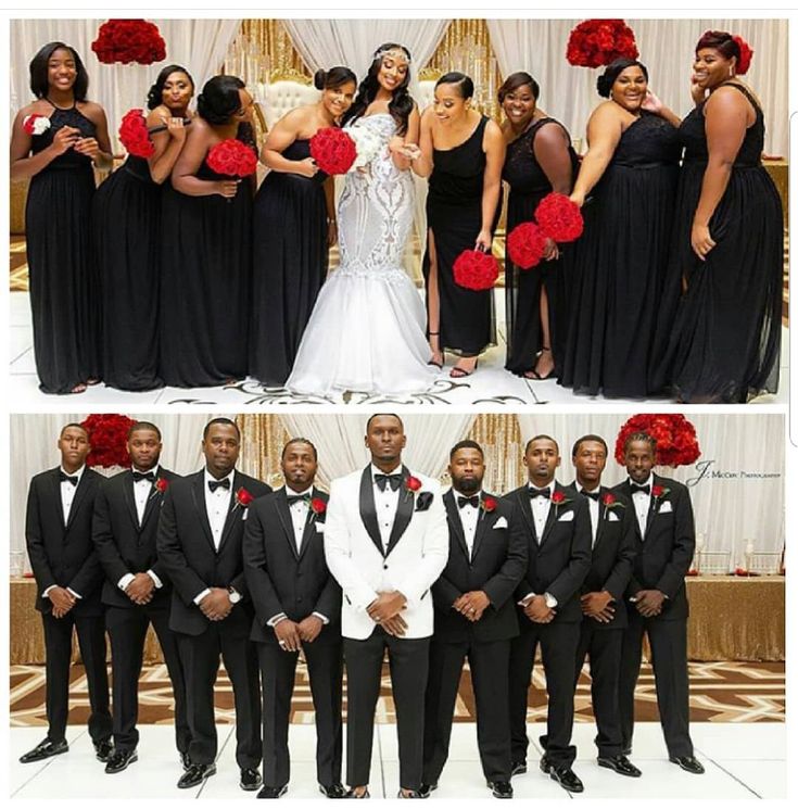 a group of people standing next to each other in front of a white wall with red flowers