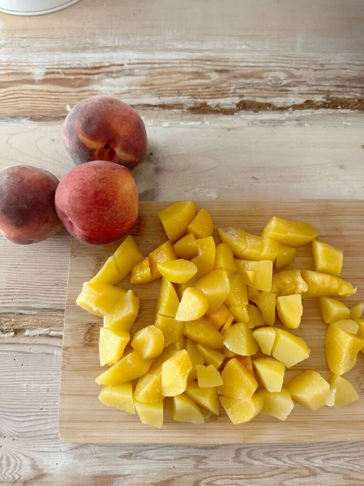 sliced mangos and peaches on a cutting board