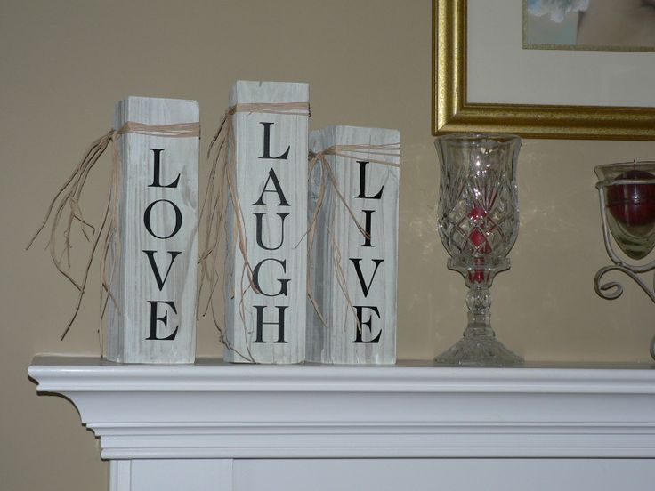 three white books sitting on top of a mantle