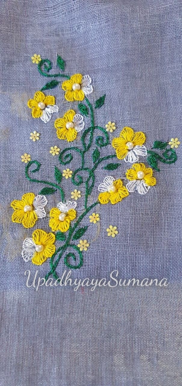 yellow and white flowers are embroidered onto a blue linen material with green stems on it