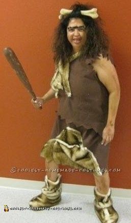 a man dressed up as a caveman holding a baseball bat