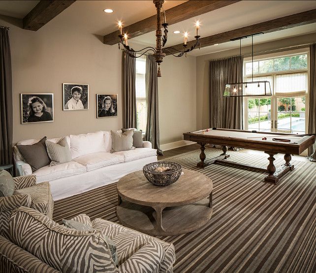 a living room filled with furniture and a pool table