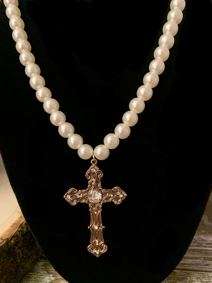 Gorgeous faux pearl necklace with golden rhinestone cross. Perfect for renaissance fairs, Halloween, or other occasions. Elegant Cross Necklace With Pearl Drop, Gold Cross Necklace With Pearl Charm, Elegant Confirmation Cross Pendant Jewelry, Elegant Cross Pendant For Confirmation, Elegant Gold Jewelry For Confirmation, Elegant Pearl Crucifix Necklace, Elegant Crucifix Pearl Necklace, Elegant Pearl Cross Necklace With Pearl Drop, Elegant Pearl Jewelry For Baptism