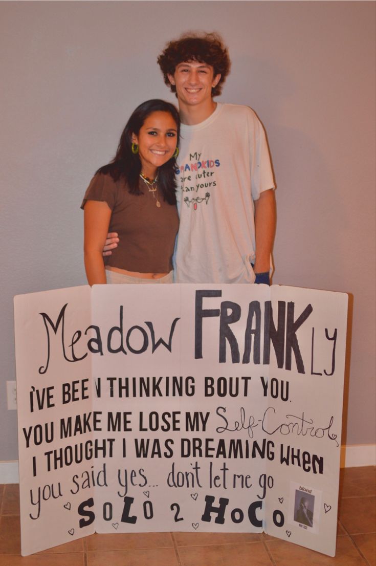 two people standing behind a sign that says meadow frankly and i've been thinking about you