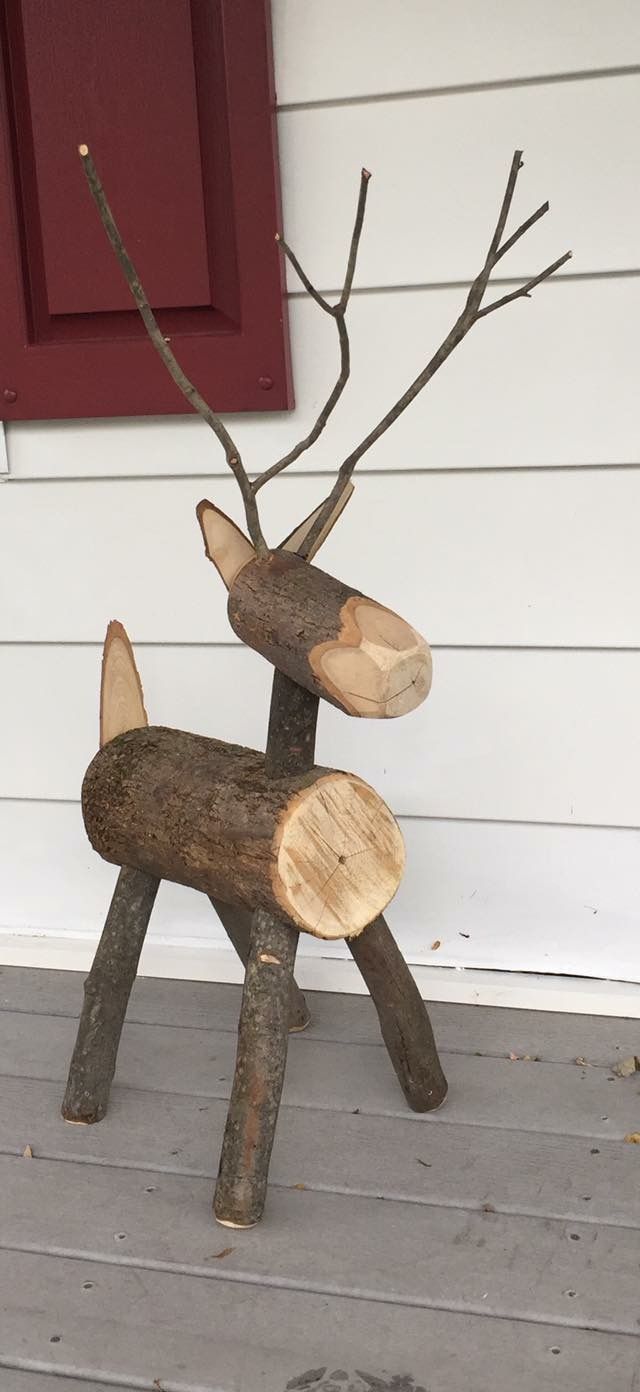 a wooden reindeer statue sitting on top of a porch