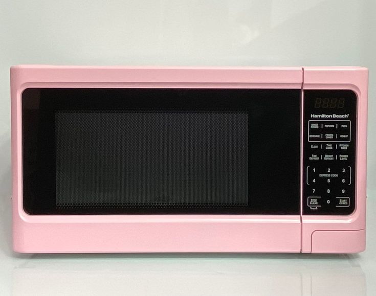 a pink microwave oven sitting on top of a counter