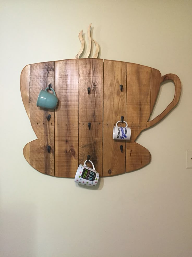 a wooden coffee cup shaped wall hanging on a wall