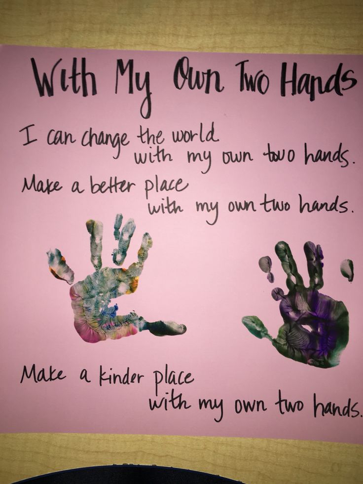 a pink sign with two handprints on it that says, with my own two hands i can change the world