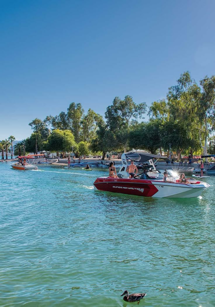 people are riding in boats on the water