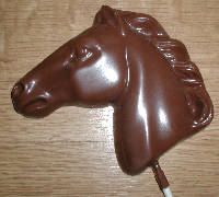 there is a chocolate horse head on top of the cake icing stick that looks like it's made out of chocolate