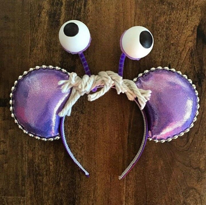 a purple and white mouse ears with googly eyes