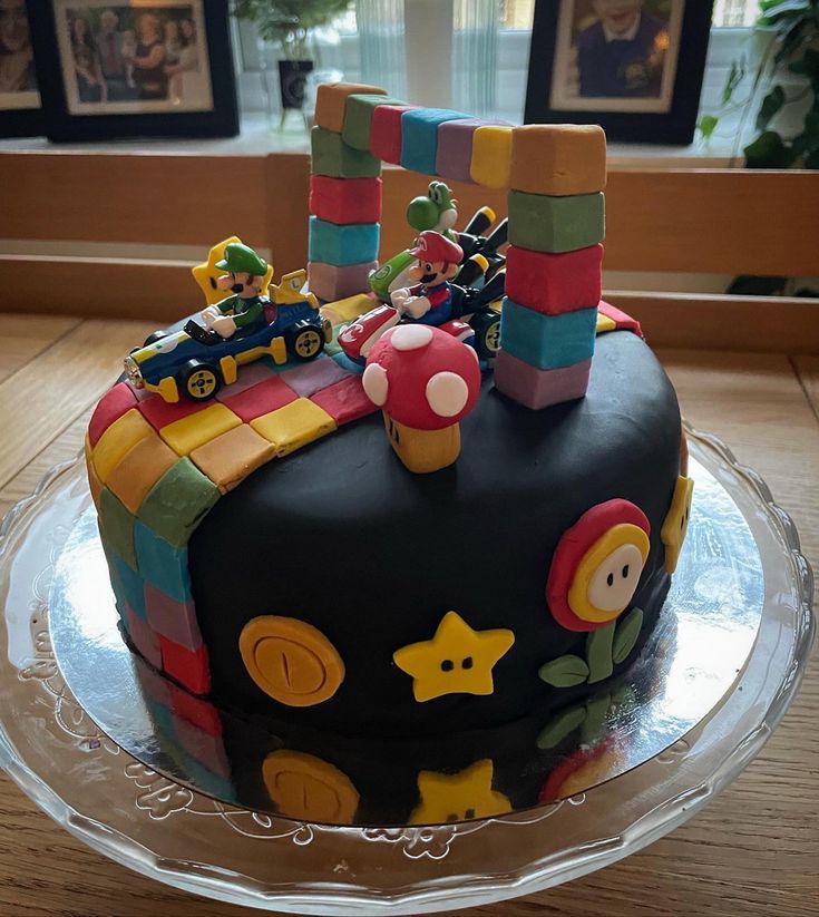 a birthday cake is decorated with legos and characters on it's top tier