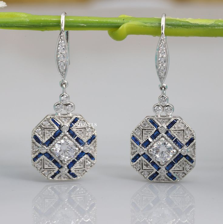 Vintage Art Deco Earrings, Drop Dangle Diamond Earrings, Engagement Wedding Earrings, Round & Sapphire Diamond 14K White Gold Over Earrings **Returns and Refunds** 30-Day Returns All our diamonds have Paid 6 Months grantee! We are fully behind every diamond and piece of jewelry that we sell. It is vital for us that you are totally happy with your purchase. If you are not 100% happy with your purchase, you can return it to us within 30 days of purchase for a full refund or exchange. Happy Shopping With VNVJEWELS ✶ Our All Jewelry Is handcrafted In such a way that it gives special touch to your dream gift. Thank You Visit Again 𝐂𝐀𝐍𝐂𝐄𝐋𝐋𝐀𝐓𝐈𝐎𝐍𝐒 𝐏𝐎𝐋𝐈𝐂𝐘 We Charge 10% of Order Value if any Order Canceled Within 24 Hours of Purchase. We Charge 20% of Order Value if any Order Canc Exquisite White Gold Dangle Earrings, White Gold Hand Set Drop Earrings, Hand Set White Gold Drop Earrings, Fine Jewelry Hallmarked Bridal Drop Earrings, Diamond Cut Chandelier Drop Earrings For Anniversary, White Gold Dangle Earrings For Anniversary, Wedding Dangle Hoop Earrings Diamond Cut, Art Deco Pierced Earrings For Formal Occasions, Art Deco Style Pierced Earrings For Formal Occasions