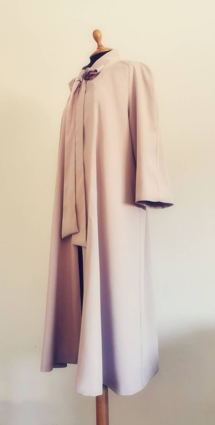 A very chic satin overcoat that will give a touch of uniqueness and elegance to every outfit. Any doubts regarding the fabric? You may now order up to five swatches and decide which one suits you best! Thank you for choosing Céleste Lilou! Elegant A-line Outerwear For Party, Elegant Solid Abaya For Fall, Elegant Solid Color Abaya For Fall, Formal Fitted Long Sleeve Cape, Long Fall Wedding Outerwear, Evening Long Sleeve Satin Outerwear, Fall Wedding Silk Outerwear, Chic Silk Wedding Outerwear, Chic Silk Outerwear For Wedding