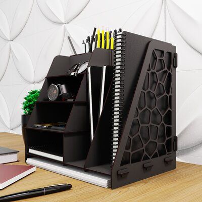 a desk with a pen holder and office supplies