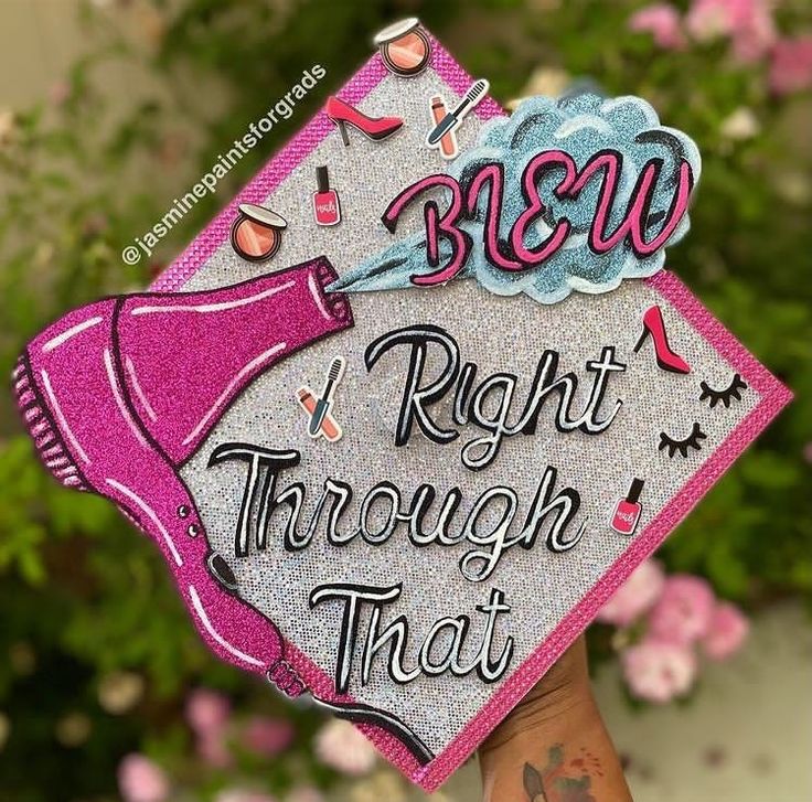 a hand holding up a pink and silver graduation cap that says, beware right through that