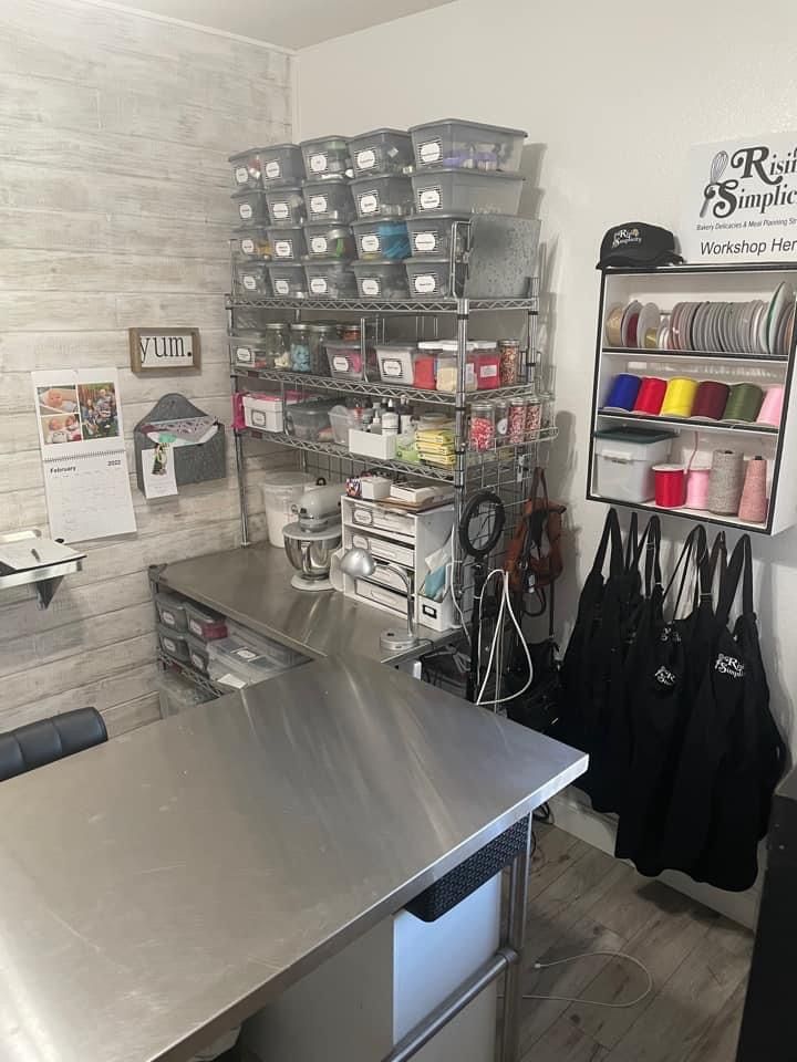 a kitchen with stainless steel counter tops and shelving units on the wall behind it