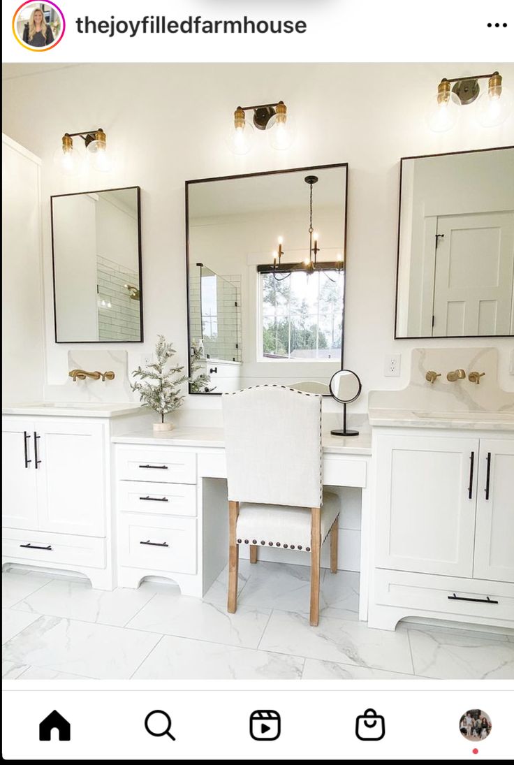 a white bathroom with two sinks and mirrors on the wall next to it's vanity