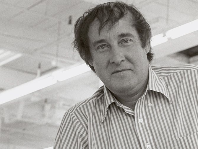 a black and white photo of a man in a striped shirt