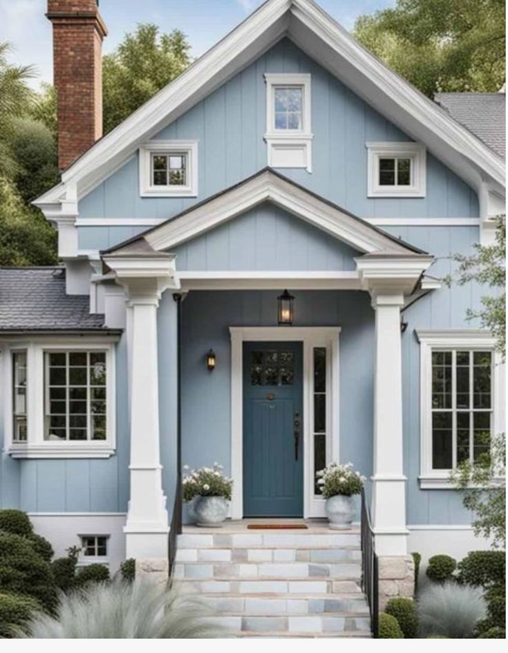 a blue house with white trim on the front door and steps leading up to it