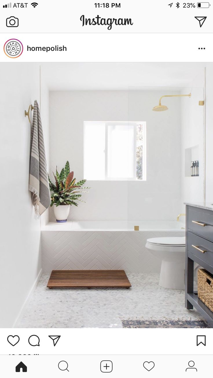 a bathroom with a toilet, sink and bathtub next to a window on the wall