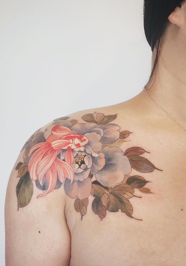 a woman with a flower tattoo on her chest