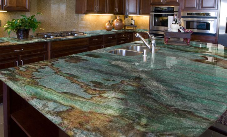 a large kitchen with marble counter tops and wooden cabinets, along with stainless steel appliances