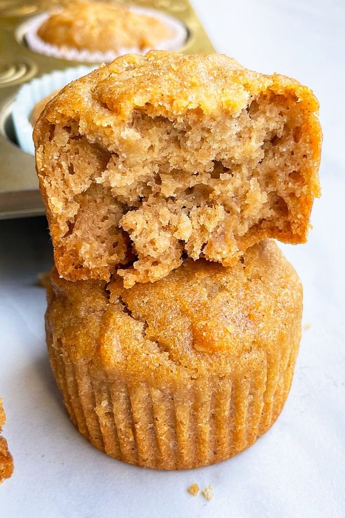 two muffins sitting next to each other on a table