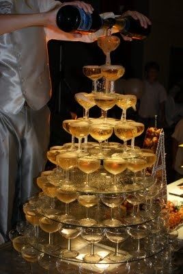 a man and woman are pouring champagne into wine glasses